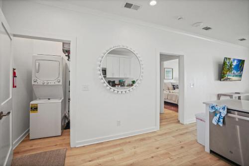 a white room with a refrigerator and a mirror at Quiet Harbor Condo-Private Balcony-Relaxing Stay in Pass Christian