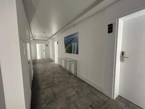 a hallway with white walls and a painting on the wall at Sea and lake apartament in Mielno