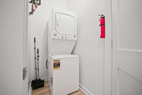 a white refrigerator with a mirror on top of it at Mississippi Gulf Coast Basecamp-Central Location in Pass Christian