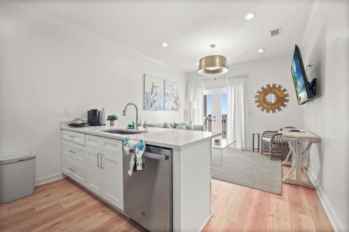 a kitchen with a sink and a counter top at Beach Access Condo-Walk to Downtown-Pets Welcome w/ Fee in Pass Christian