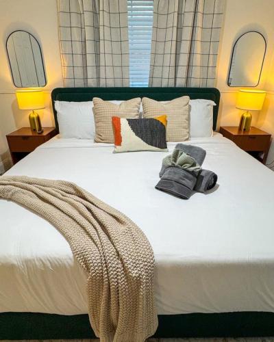a bedroom with a large white bed with pillows at Waterfront home with Firepit and Foosball Table in Fruitland Park