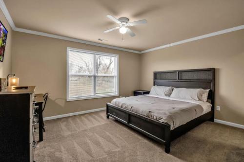 a bedroom with a bed and a ceiling fan at Spacious 3 bed 3 bath Apartment No stairs in Buffalo