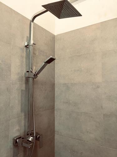 a shower with a shower head in a bathroom at VOGEL NEST in Midigama East