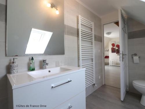 a white bathroom with a sink and a toilet at Longère spacieuse avec jardin à Saint-Evroult, animaux admis sur demande - FR-1-497-257 in Touquettes