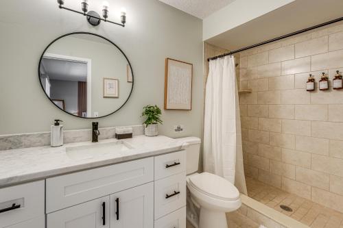 a bathroom with a sink and a toilet and a mirror at Modern Coastal Escape 1 Mi to Anclote River Park in Anclote