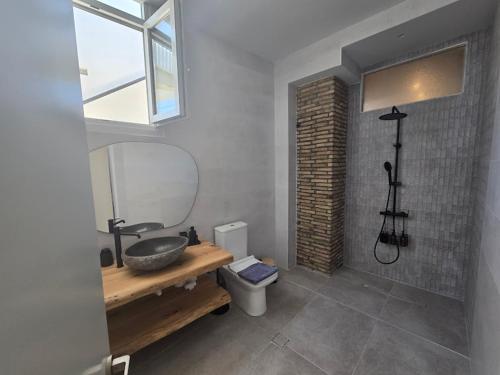 a bathroom with a sink and a toilet at Ilia Suites ''Paralia'' in Ilia