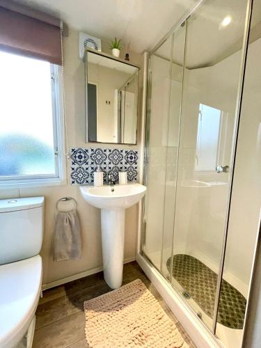 a bathroom with a sink and a shower at Billing Aquadrome - Bird Lake View in Great Billing
