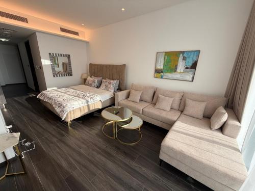 a living room with a couch and a bed at Sea View Studio Perfect for Couples In Harbour Row in Manama