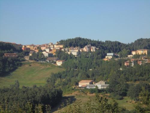 a small town on a hill with houses at La Calla in Monghidoro