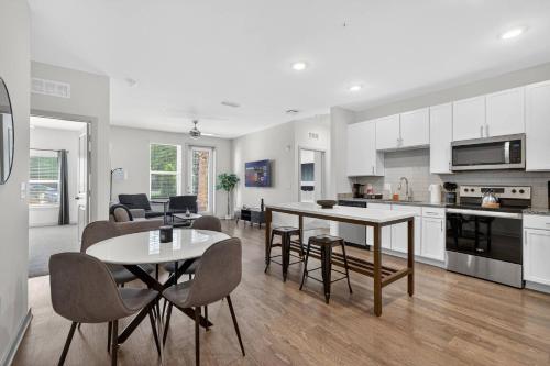 a kitchen and living room with a table and chairs at Cozy 2 BR Apt |King Bed |Pool |Gym| Close to Mayo in Jacksonville