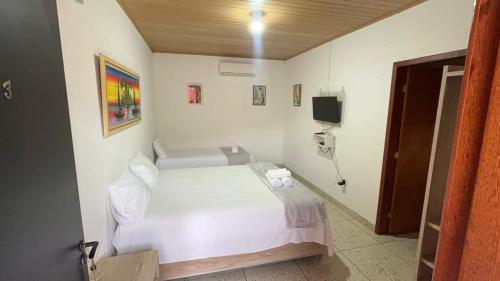 Ένα ή περισσότερα κρεβάτια σε δωμάτιο στο Pousada Café Na Mata