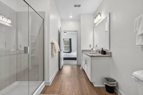 a bathroom with a shower and a sink at Cozy 2 BR Apt |King Bed |Pool |Gym| Close to Mayo in Jacksonville