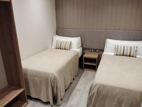 Ένα ή περισσότερα κρεβάτια σε δωμάτιο στο Hotel Vélez