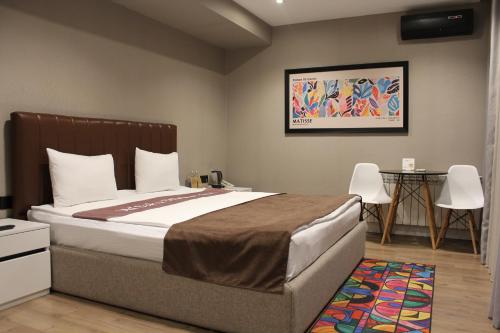 a bedroom with a bed and a table and chairs at Old Baku Boutique Hotel in Baku