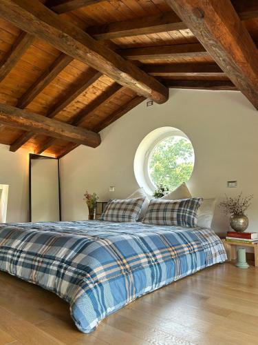 a bedroom with a bed with a large window at Villa FARFA in Castelnuovo di Farfa