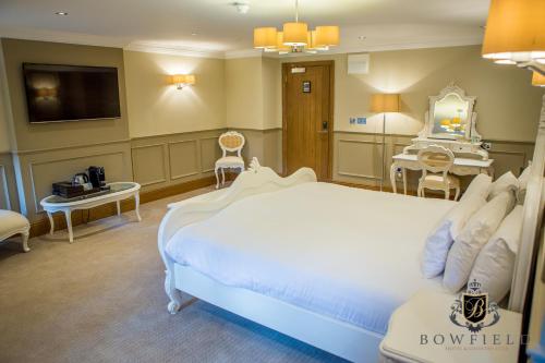 a hotel room with a bed and a tv at Bowfield Hotel and Spa in Howwood
