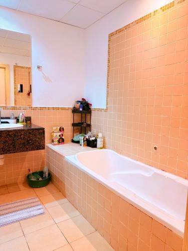 a large bathroom with a tub and a sink at WAHA WOW Bed space Available in Luxury Apartment 101 in Sabkhah