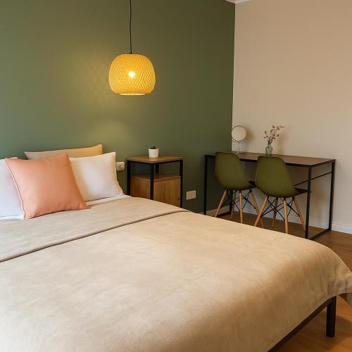 a bedroom with a bed and a table and chairs at ZiAna - Hiperbara Livezeni in Livezeni