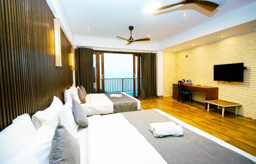 a bedroom with two beds and a desk and a television at Hillcrest Ella in Ella