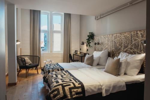 a hotel room with a large bed and a window at Home Hotel Magasinet in Trelleborg