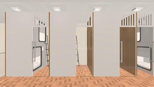 an empty room with glass doors and wooden floors at Cápsula Hotel in Florianópolis