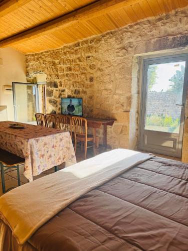 a bedroom with a bed and a table and a window at Casa Betta in Modica