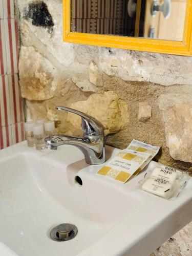 a white bathroom sink with a mirror and a sink at Casa Betta in Modica