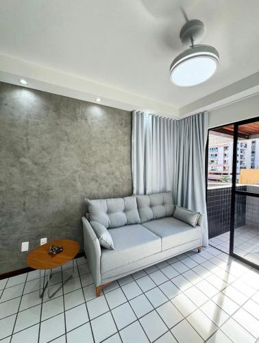 a living room with a couch and a table at Edifício Atlantis Hotel in Maceió