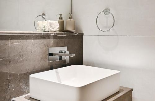 a bathroom with a white sink and a mirror at Dubai JVC - Oxford Residence 2 - Parking&Balcony in Dubai