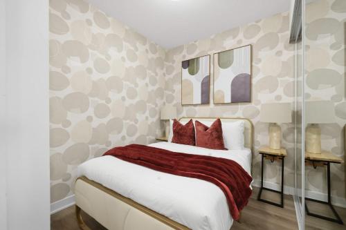a bedroom with a large bed with red pillows at Cozy 2BR Condo with Free Parking & City Views in Toronto