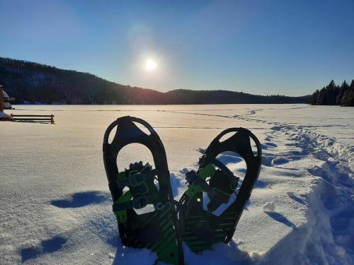 a pair of snow skis sitting in the snow at La Passion #204 - Loft with private balcony and view in Sainte-Lucie-de-Doncaster