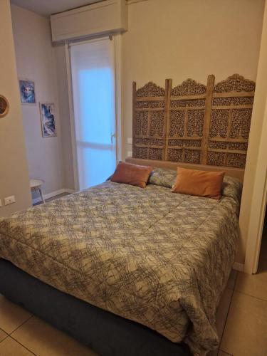 a bedroom with a bed with two pillows on it at Nyx Lilura Seriate in Seriate