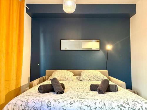 a bedroom with a bed with two pillows on it at Dalikyda - La Bulle - Loveroom in Le Havre