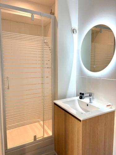 a bathroom with a sink and a glass shower at Dalikyda - La Bulle - Loveroom in Le Havre