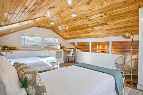 a bedroom with two beds and a wooden ceiling at Waterfront Retreat Events Dock in St. Augustine
