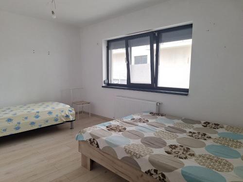 Postel nebo postele na pokoji v ubytování Apartament Sos Alexandriei Bragadiru