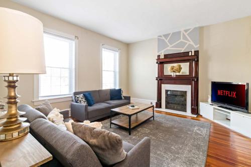 a living room with a couch and a fireplace at Pet-Friendly Benton Park 1BR Apt with Private Backyard in Soulard