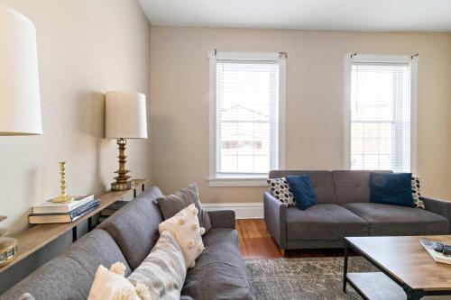 a living room with a couch and a table at Pet-Friendly Benton Park 1BR Apt with Private Backyard in Soulard