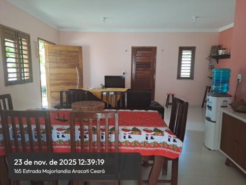 a living room with a table and a kitchen at Casa Canoa Aracati in Aracati