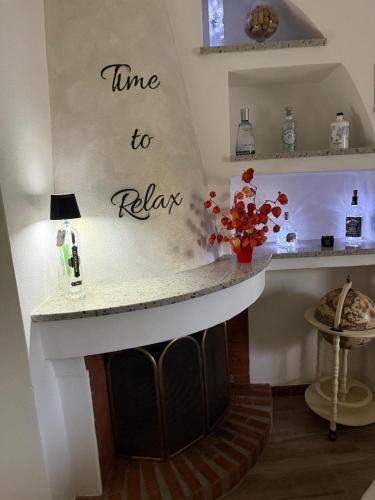 a kitchen with a fireplace with the words time to return at La Suite nella Valle in Trecchina