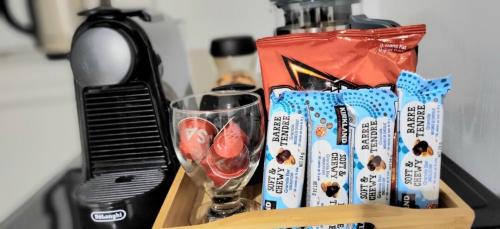 a counter top with a bottle of wine and a glass at Cozy 1BR in Vieux-Longueuil +parking 14min Downtown in Longueuil