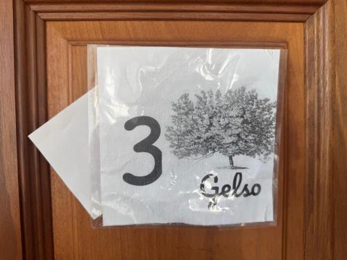 a sign on a door with a tree on it at La Locanda della Mandria 1 in Venaria Reale