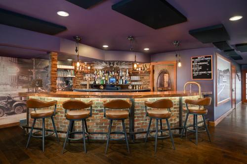 a bar with brown stools in a room at The Horton Hotel in Boone