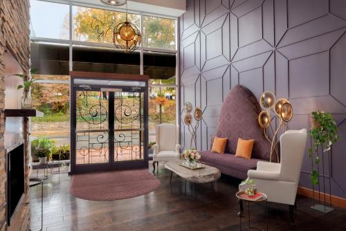 a living room with a purple couch and a fireplace at The Horton Hotel in Boone