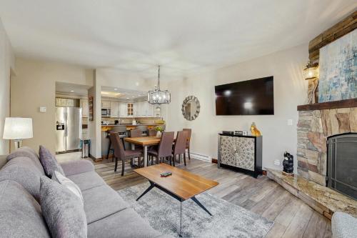 a living room with a couch and a fireplace at Mountainwood 303 in Breckenridge