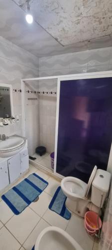 a bathroom with a toilet and a sink at serenity house 