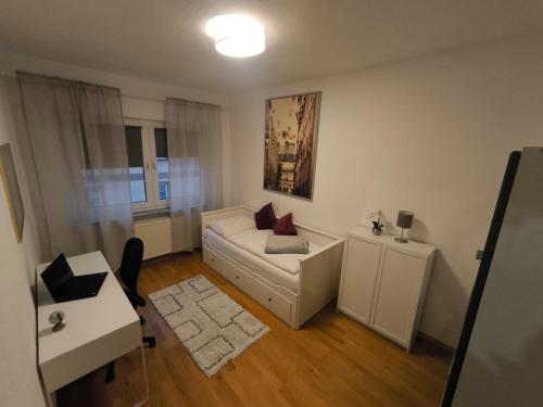 a living room with a white couch and a table at Düsseldorf Apartment in Düsseldorf
