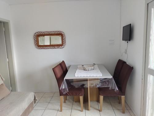 tavolo da pranzo con sedie e specchio di Apto 2 Dorm Vista para Mar a Capão da Canoa