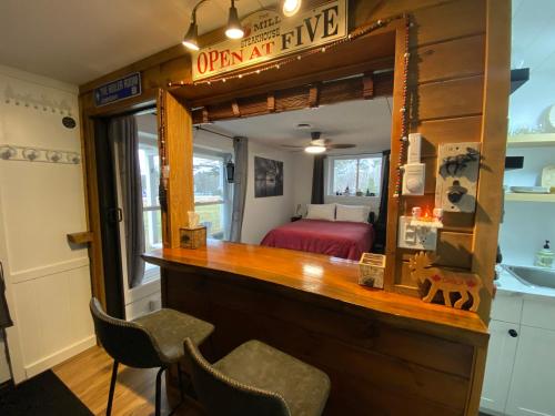 a room with a vanity with a mirror and a bedroom at Our Place Up North BnB in Huntsville