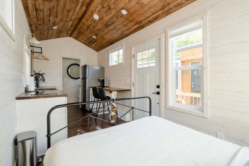 a bedroom with a bed and a window at Stay Portland - The Tiny Farmhouse on Alberta in Portland